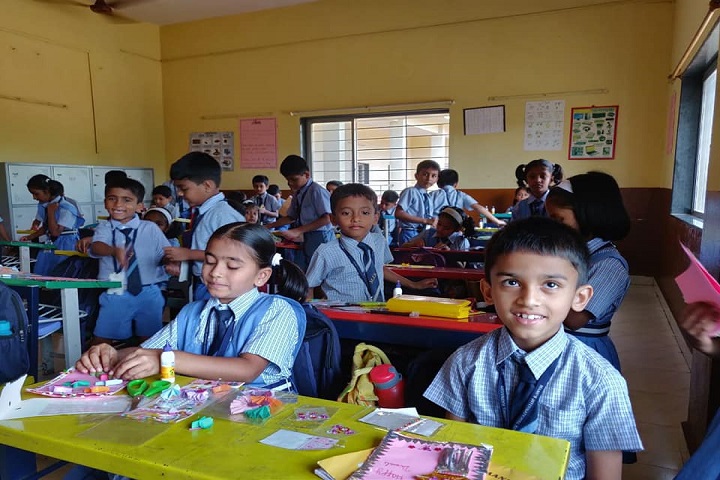 Students displaying artwork in class